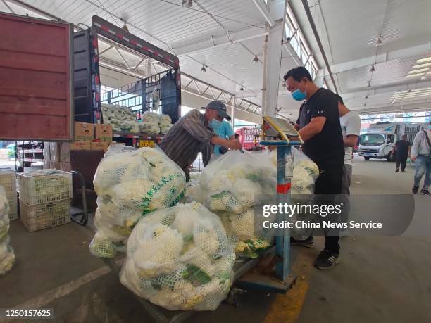 People buy vegetables at Hebei Xinfadi agriculture products wholesale market, which belongs to Beijing Xinfadi Market, on June 16, 2020 in Baoding,...