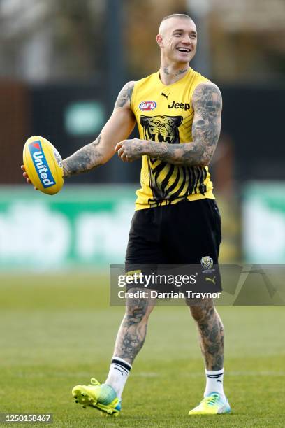 Dustin Martin of the Tigers laughs during a Richmond Tigers AFL training session at Punt Road Oval on June 17, 2020 in Melbourne, Australia.