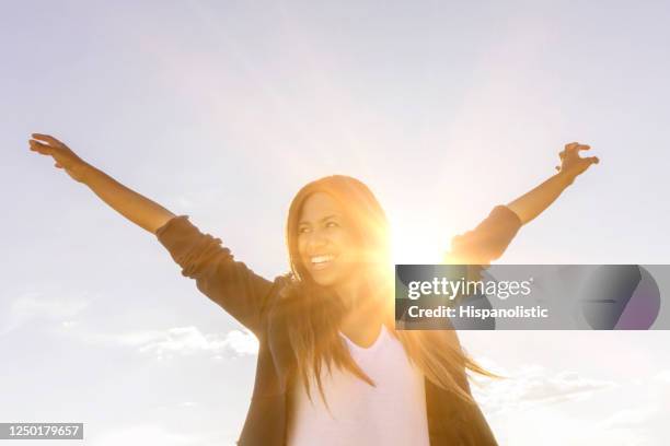 happy woman enjoying the sunshine outdoors - enlightenment stock pictures, royalty-free photos & images