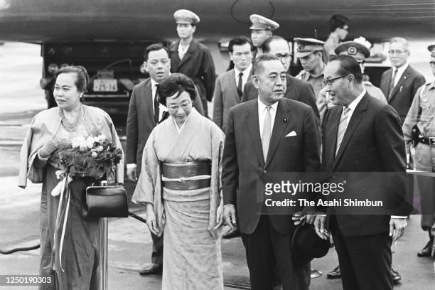 Burma's Union Revolutionary Council Chairman Ne Win and his wife are welcomed by Japanese Prime Minister Eisaku Sato and his wife Hiroko on arrival...