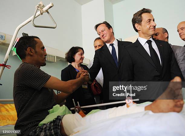 British Prime Minister David Cameron and French President Nicolas Sarkozy visit Tripoli Medical Centre as part of their trip following the country's...