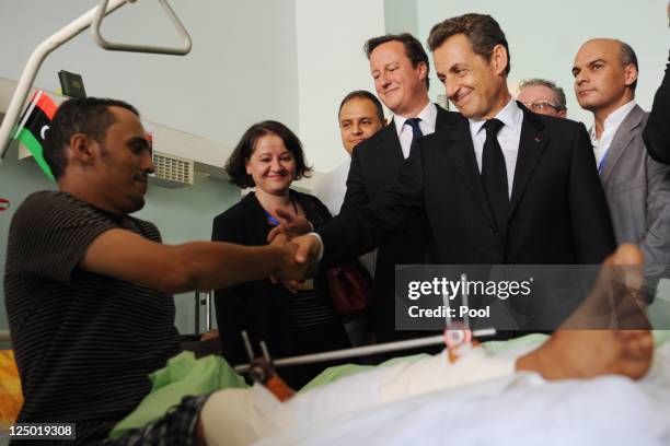 British Prime Minister David Cameron and French President Nicolas Sarkozy visit Tripoli Medical Centre as part of their trip following the country's...