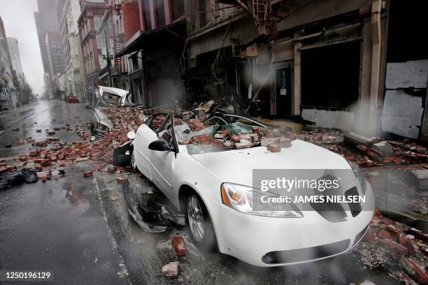 Cars sit along a side street damaged by falling debris in the French quarter of New Orleans, 29 August 2005, as Hurricane Katrina makes landfall....