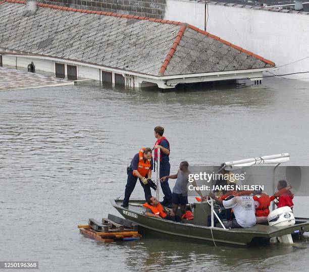 Emergency personnel rescue residents from submerged houses in New Orleans, 29 August 2005, after Hurricane Katrina made landfall. Hurricane Katrina...