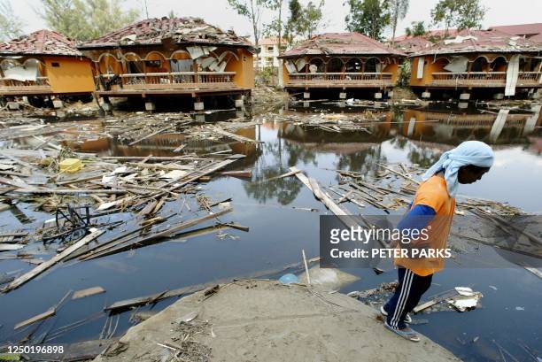 Man looks out at the remains of a hotel resort in Khao Lak in Thailand's Phang Nga province, 09 January 2005 which took the full force of the...