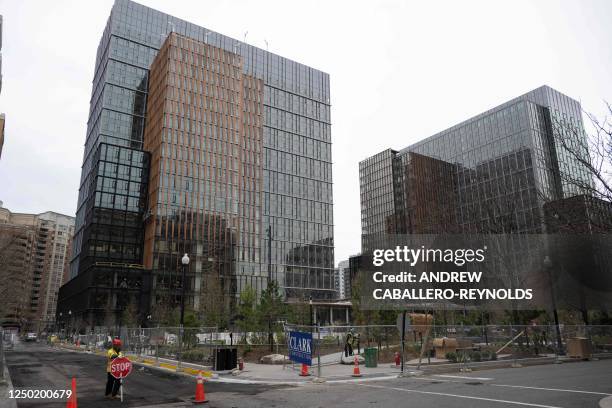 Construction worker with a stop sign stands at an intersection near a building that is part of Amazon's HQ2 offices in Crystal City in Arlington,...