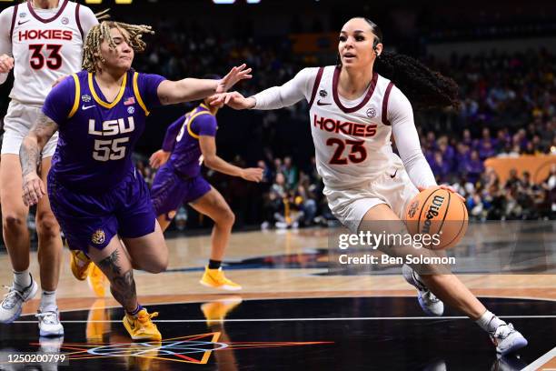 Kayana Traylor of the Virginia Tech Hokies drives to the basket against Kateri Poole of the Louisiana State Tigers during the semifinals of the NCAA...