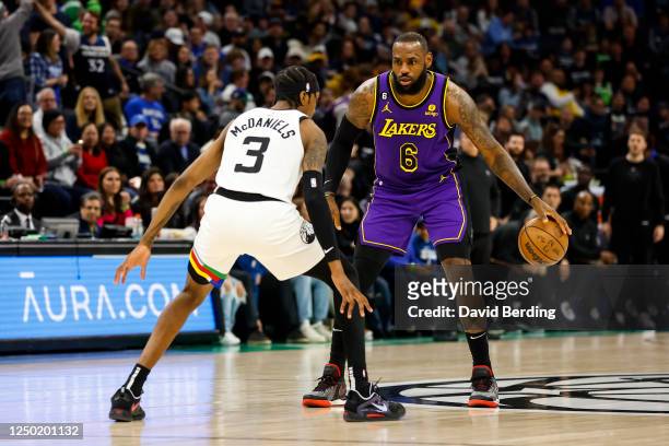 LeBron James of the Los Angeles Lakers dribbles the ball while Jaden McDaniels of the Minnesota Timberwolves defends in the first quarter of the game...