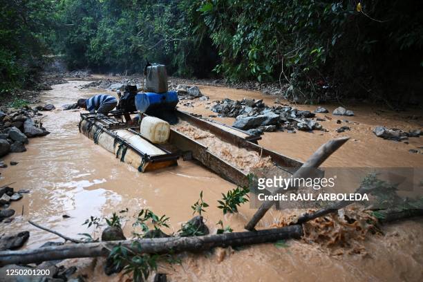 Informal miner Jose Mena looks for gold at the Nechi river in El Bagre municipality, Antioquia department, Colombia on March 23, 2023. - The giant...