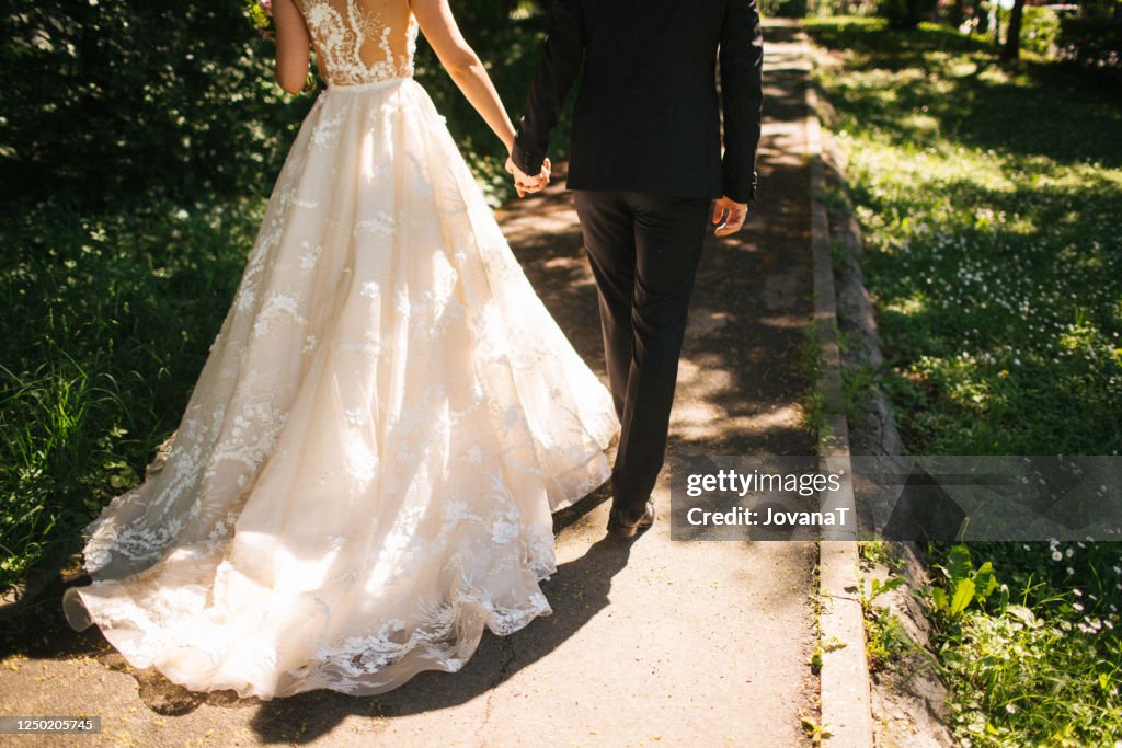Bride and groom walking on pavements