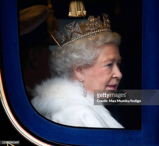 Queen Elizabeth II travels down The Mall, from Buckingham Palace to the Palace of Westminster, in the horse drawn Irish State Coach to attend the...
