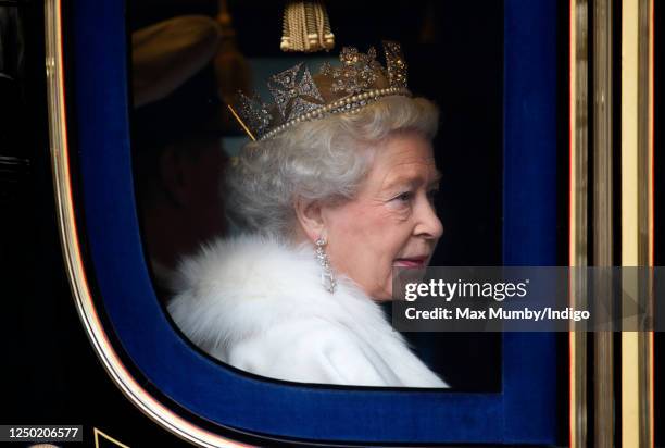 Queen Elizabeth II travels down The Mall, from Buckingham Palace to the Palace of Westminster, in the horse drawn Irish State Coach to attend the...