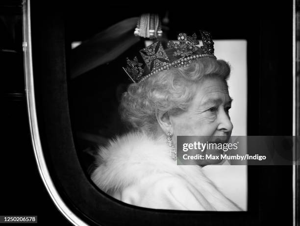 Queen Elizabeth II travels down The Mall, from Buckingham Palace to the Palace of Westminster, in the horse drawn Irish State Coach to attend the...