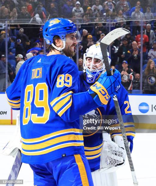 Alex Tuch of the Buffalo Sabres congratulates Devon Levi after his first NHL game and victory, a 3-2 overtime win against the New York Rangers during...
