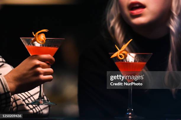 Couple drinking cocktails in a restaurant, on March 28 in Krakow, Poland.