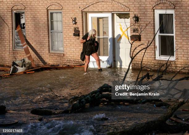Woman evacuates from her home after a large tornado damaged hundreds of homes and buildings on March 31, 2023 in Little Rock, Arkansas. Tornados...