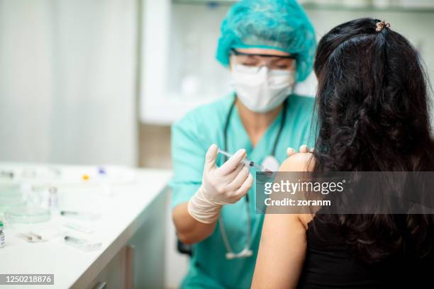 patient injected with coronavirus vaccine - respiratory disease stock pictures, royalty-free photos & images