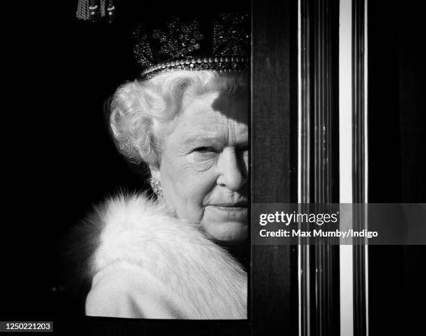 Queen Elizabeth II travels down The Mall, from Buckingham Palace to the Palace of Westminster, in the horse drawn Irish State Coach to attend the...