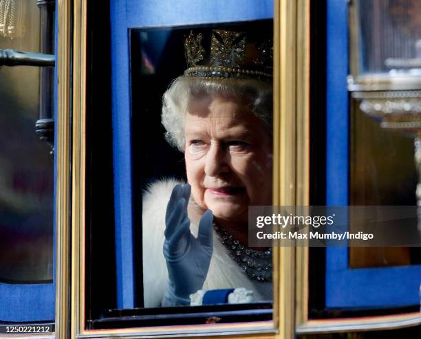 Queen Elizabeth II travels down The Mall, from Buckingham Palace to the Palace of Westminster, in the horse drawn Irish State Coach to attend the...