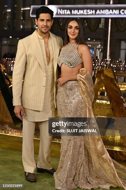 In this picture taken on March 31 Bollywood actor Sidharth Malhotra and actress Kiara Advani pose for pictures during the inauguration of the Nita...