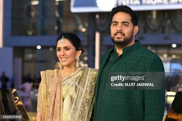 In this picture taken on March 31 Akash Ambani , son of Indian businessman Mukesh Dhirubhai Amani, and his wife Shloka Mehta pose for pictures during...