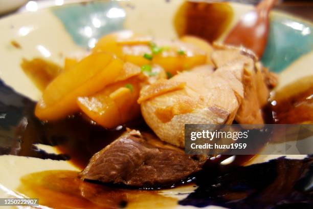 simmered yellowtail and daikon radish in soy sauce - sudderen stockfoto's en -beelden