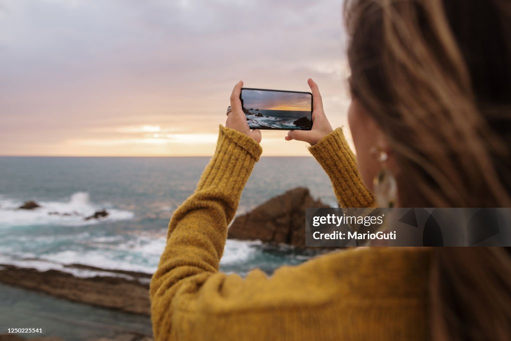 Woman taking a picture with a smartphone