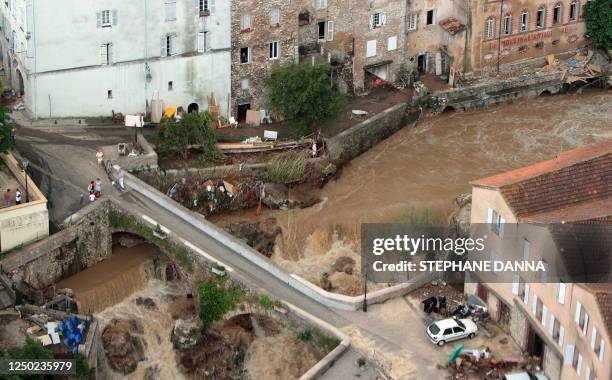 An aerial picture shows a bridge over the overflowed Nartuby river in the French southeastern city of Trans-en-Provence, on June 17, 2010 in the...