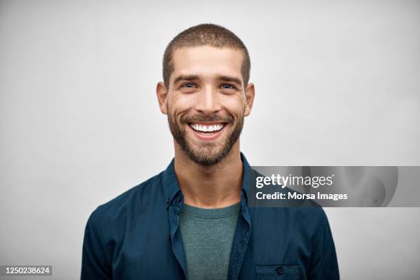 handsome young adult businessman with stubble - sorridere foto e immagini stock