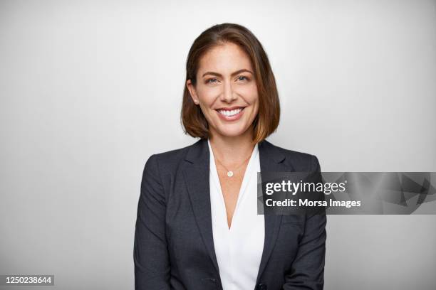 portrait of businesswoman against white background - white jacket imagens e fotografias de stock