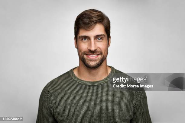 portrait of handsome smiling man in casuals - portrait stock-fotos und bilder