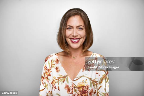 portrait of smiling mid adult woman in casuals - woman's blouse stock pictures, royalty-free photos & images