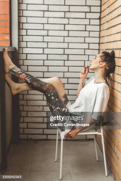 girl house balcony with her doll during lockdown period due to covid-19 epidemic. - woman leg spread stock pictures, royalty-free photos & images