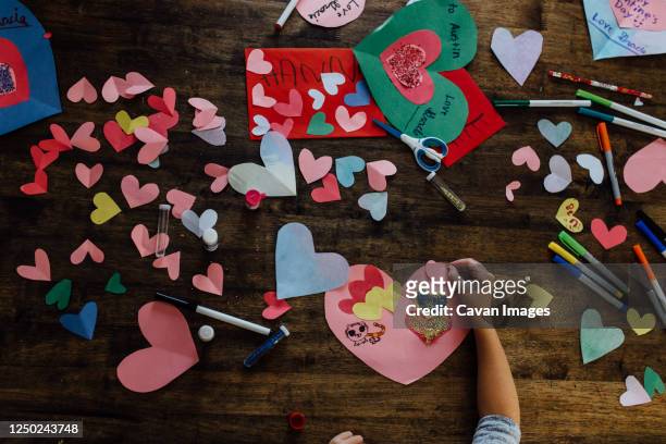 overhead view of girl creating valentines crafts and cards - child craft stock pictures, royalty-free photos & images