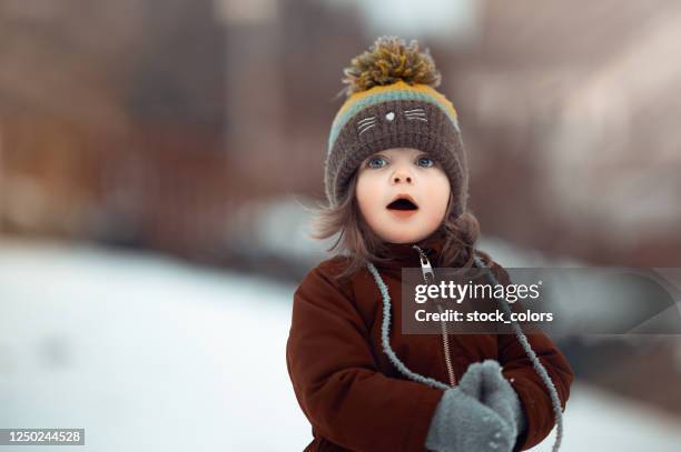 snowflakes and magic... so surprised and happy - winter baby stock pictures, royalty-free photos & images