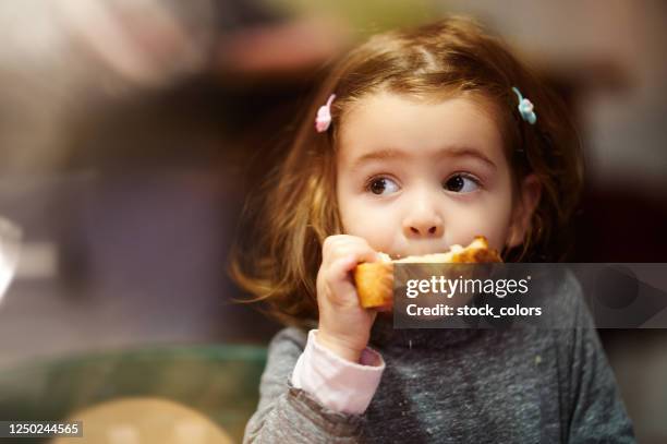 this bread is delicious - childhood hunger stock pictures, royalty-free photos & images