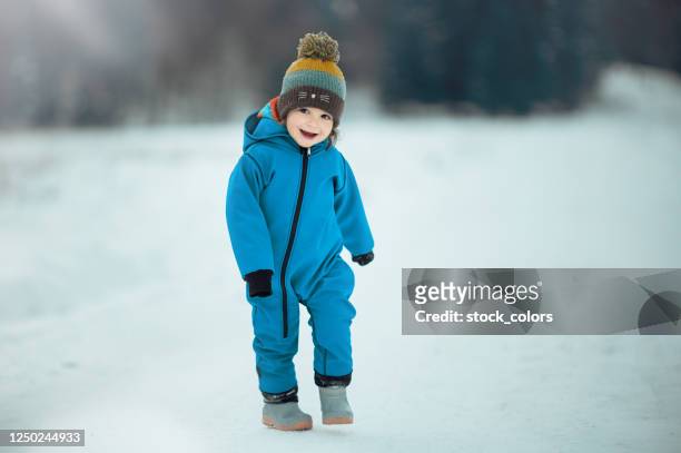 laughing and feeling happy in nature in winter time - kid in winter coat stock pictures, royalty-free photos & images