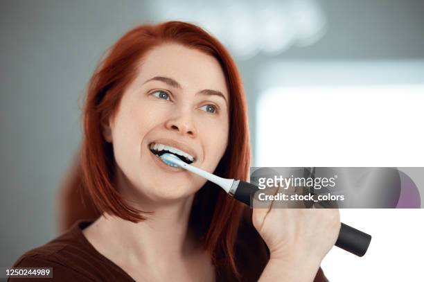 liefdevolle de ochtend routine - electric toothbrush stockfoto's en -beelden