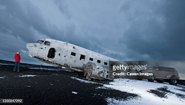 woman exploring famous plane wreck in iceland - aerospace engineering stock pictures, royalty-free photos & images