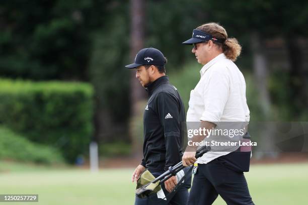 Xander Schauffele of the United States walks with his father and coach Stefan Schauffele during a practice round prior to the RBC Heritage on June...