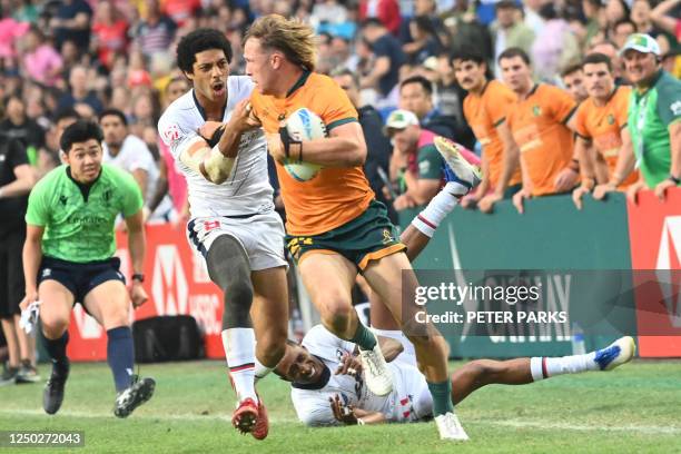 Malacchi Esdale of the US tackles Australias Hayden Sargeant on the second day of the Hong Kong Sevens rugby tournament on April 1, 2023.