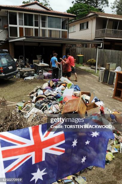 The Novak family start the clean-up of their flood-devastated home in Ipswich near Brisbane on January 14, 2011. As the flood waters drained from the...