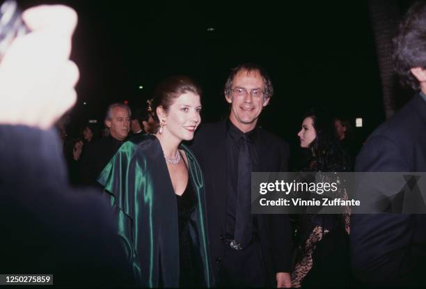 American actor Christopher Lloyd and an unidentified woman attend the premiere of "The Addams Family" at the Academy Theater in Beverly Hills,...