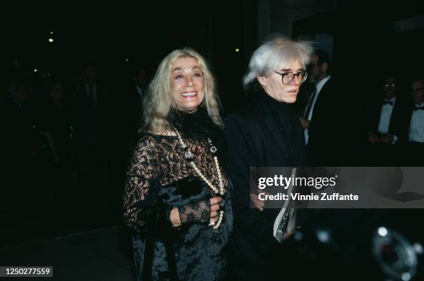 American actress Sylvia Miles and American artist, film director, and producer Andy Warhol attend the Film Society of Lincoln Center Tribute to Liz...