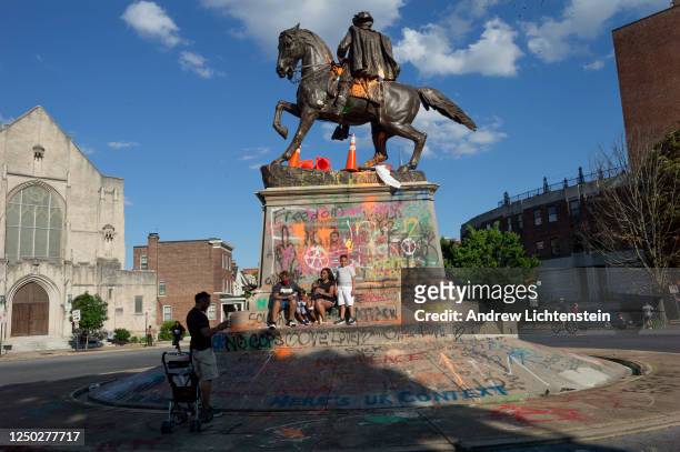People visit the graffiti-covered statue of Confederate General JEB Stuart on June 14, 2020 at Monument Avenue in Richmond, Virginia. The killing of...