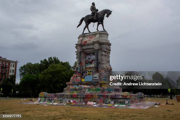 The graffiti-covered statue of Confederate General Robert E. Lee catches the early morning light on June 15, 2020 at Monument Avenue in Richmond,...