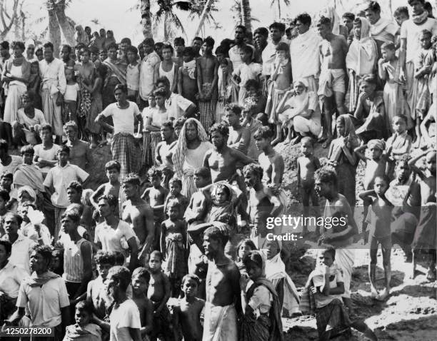 Survivors wait for help after the massive Bhola tropical cyclone that hit East Pakistan and India's West Bengal on November 12, 1970. It was the...