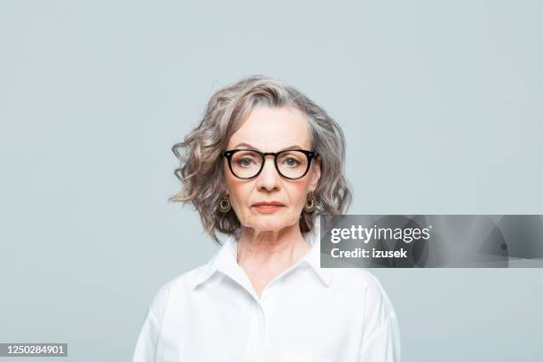 headshot of elderly businesswoman in white shirt - mature female models stock pictures, royalty-free photos & images