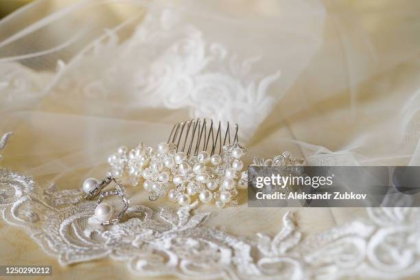 the bride's hair clip and earrings are on the veil. wedding day. - pageant tiara stock pictures, royalty-free photos & images