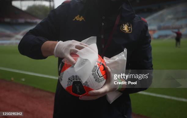 Detailed view as the match ball is disinfected after the players warm up prior to the Premier League match between Aston Villa and Sheffield United...